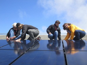 Media get hands dirty during SunPower solar installation