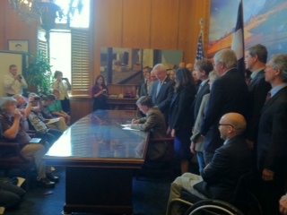 Gov. Hickenlooper signs the rural RPS into law. Courtesy Alliance for a Sustainable Colorado