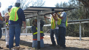 Installers putting in a commercial PV system