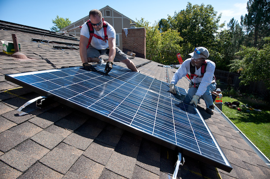REC Solar installing solar on a rooftop. Courtesy NREL.